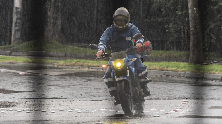 person riding motorcycle in rain