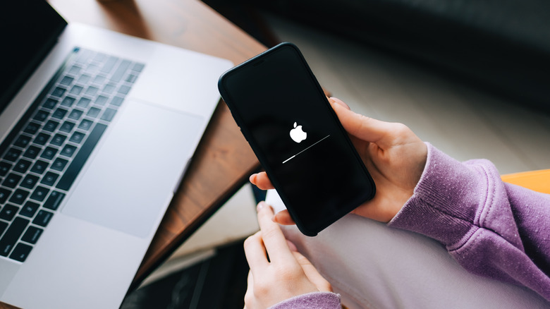 person holding booting iPhone