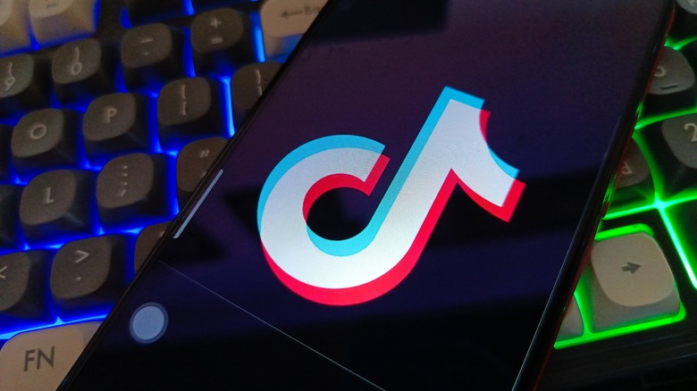 TikTok logo on a smartphone, on a computer keyboard
