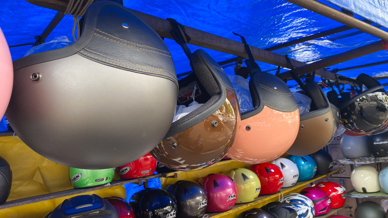 different kinds of motorcycle helmets at a street store