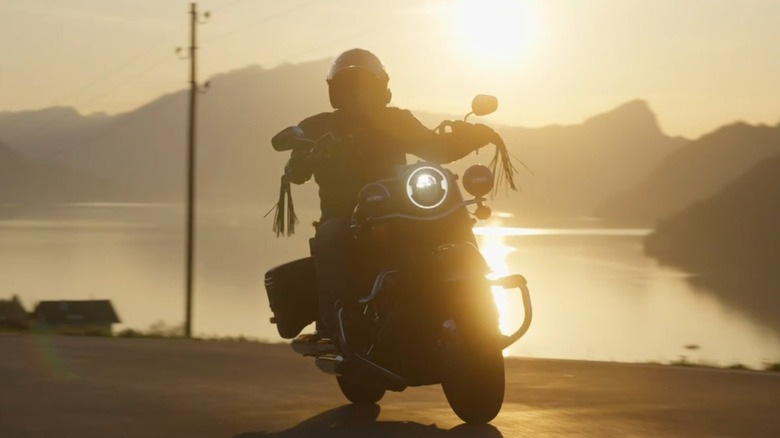 A backlit person riding a Harley in the Sun