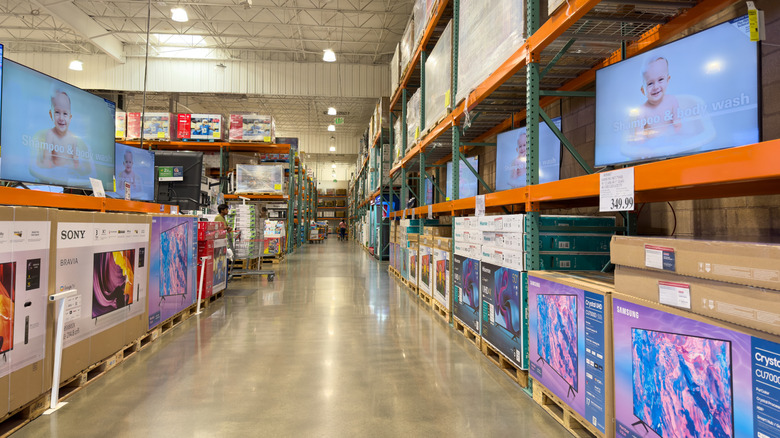 Costco warehouse interior with TV department in view.