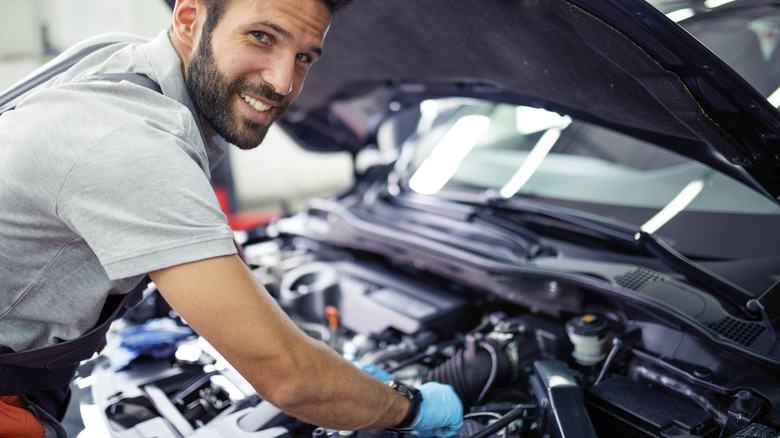 Man working on car engine