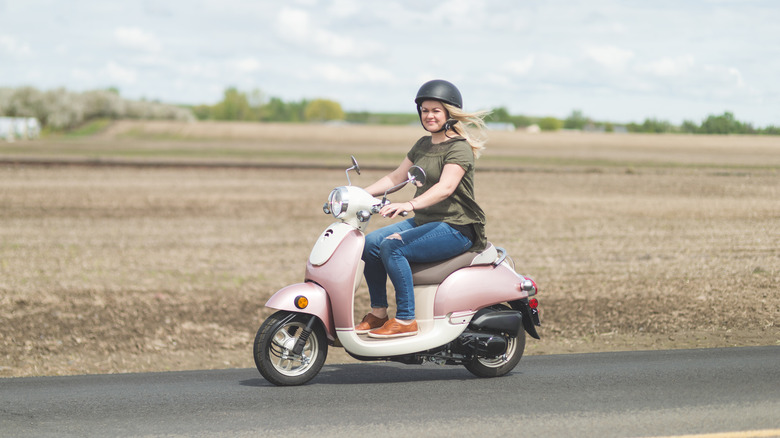 Woman riding a Vespa