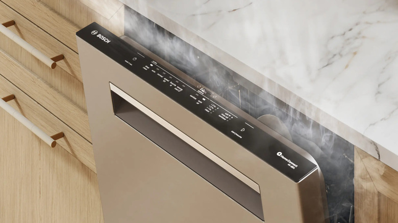 A stainless steel Bosch 500 Series 24-inch dishwasher opened up and expelling steam