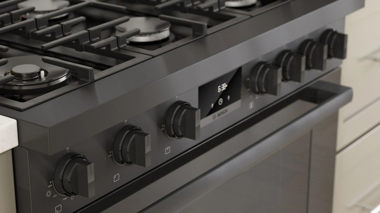 A close-up shot of a black stainless steel 36-inch Bosch gas freestanding range in a kitchen counter