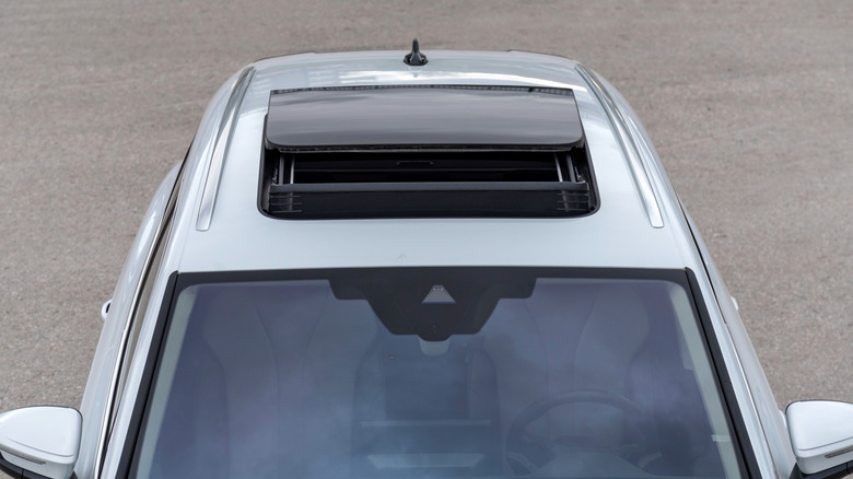 Overhead view of open sunroof on silver SUV.