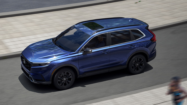 Overhead view of blue Honda CR-V driving on city street.