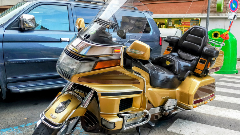 Yellow Honda Gold Wing cruiser parked on edge of crosswalk