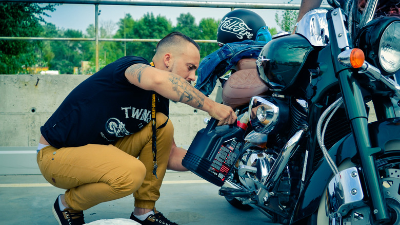 A biker changing oil on his Harley-Davidson bike