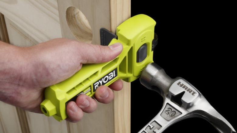 Person using Ryobi mortiser attachment on door