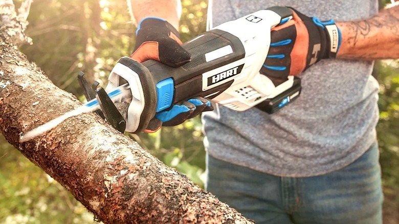 Person using Hart reciprocal saw from Walmart kit