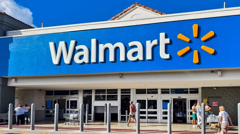 People walking int the front door of a Walmart store