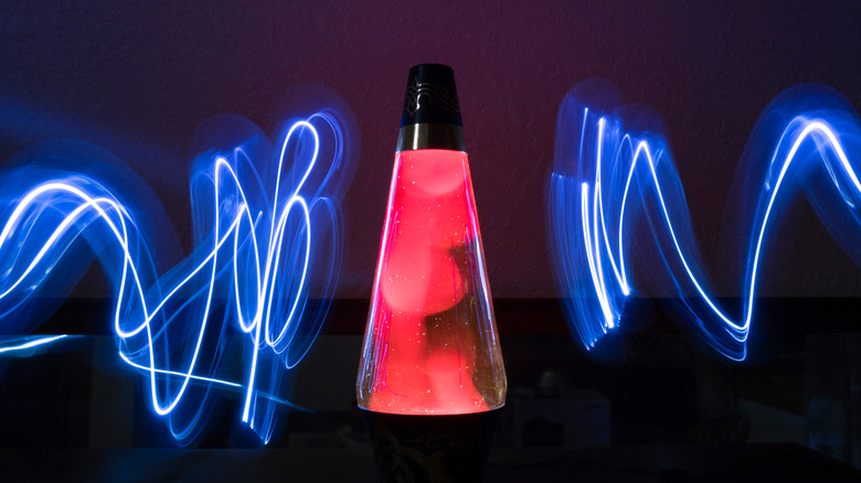 A long-exposure image showing light painting around a lava lamp.
