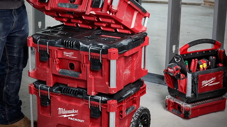 Man standing beside Milwaukee tools stacked Packout toolbox