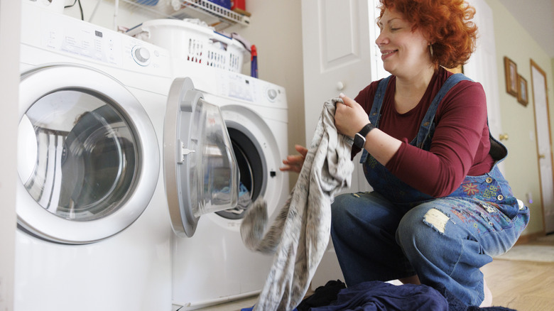 Woman removing items from her clothes dryer