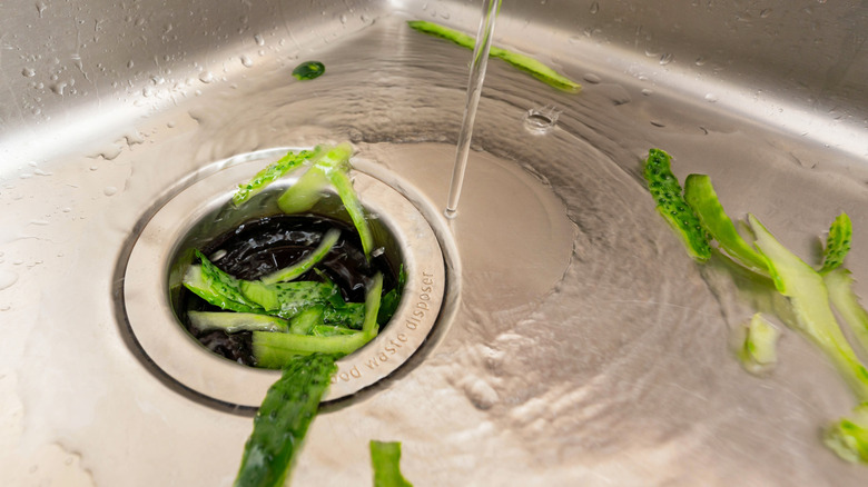 Remnants of food washing down the sink into a waste disposal.