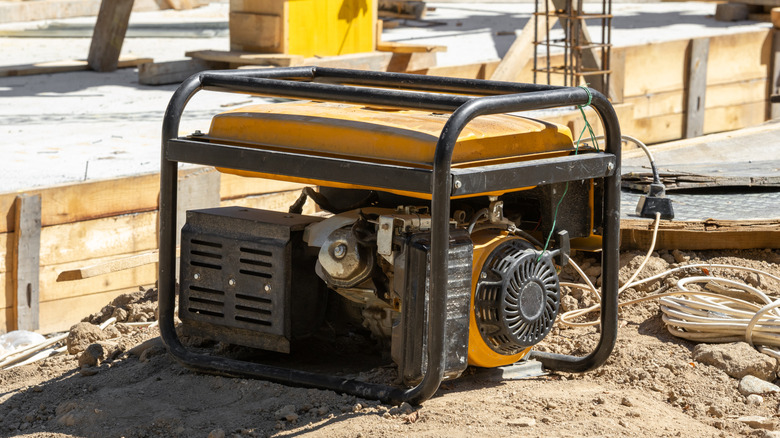 Robust portable generator on dirt ground at a residential construction site