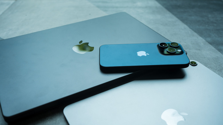 iPad Air M2 and Macbook Pro with iPhone 15 pro lies on Macbook body