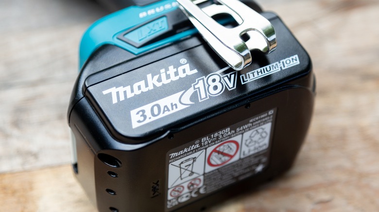 Close-up of a Makita battery attached to a drill.