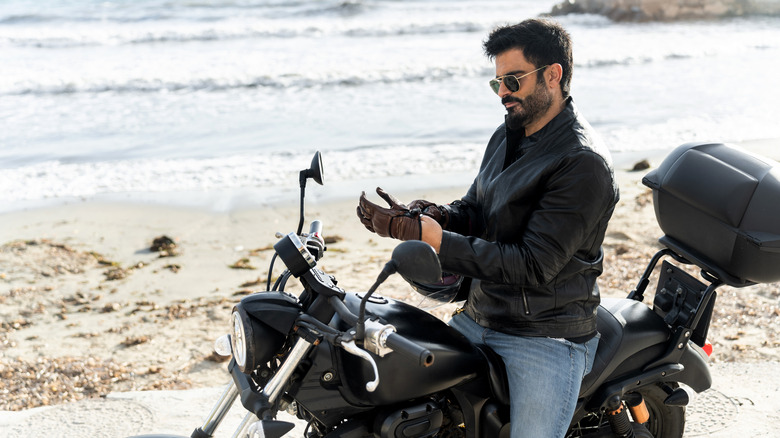 Motorcyclist riding by the ocean