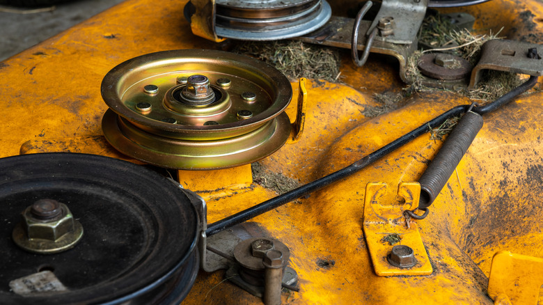 Close-up of components on a mower deck.