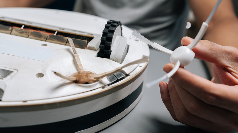 taking apart robot vacuum to clean it