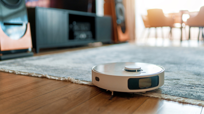 white robot vacuum on living room floor