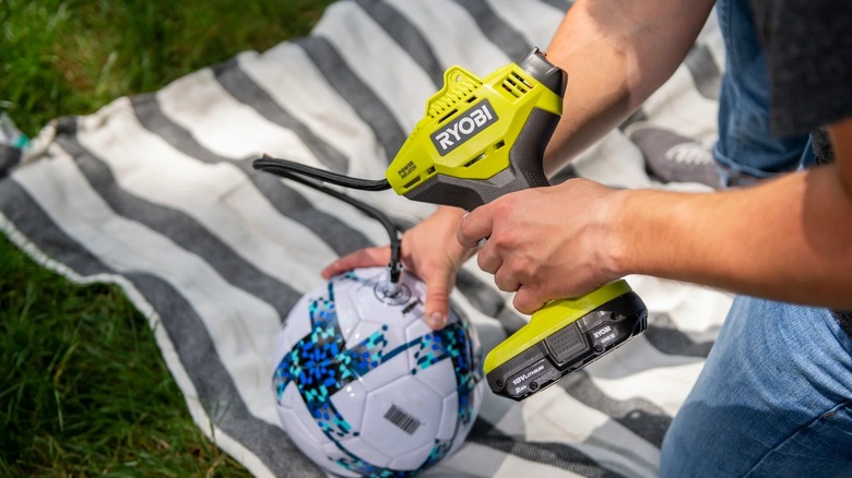Ryobi tool with Ryobi battery inflating a ball