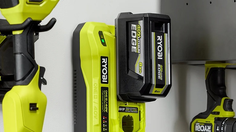 Ryobi battery connected to charger in garage
