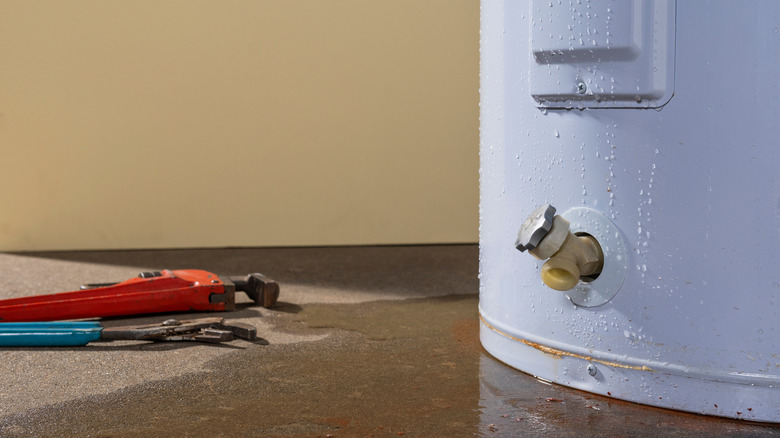 A water heater leaking its contents across the floor