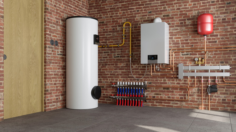 A water heater tucked away in the corner of a a clean, brick-walled utility room