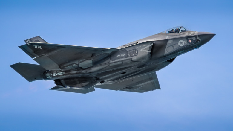 A sleek F-35 fighter jet soars through the sky
