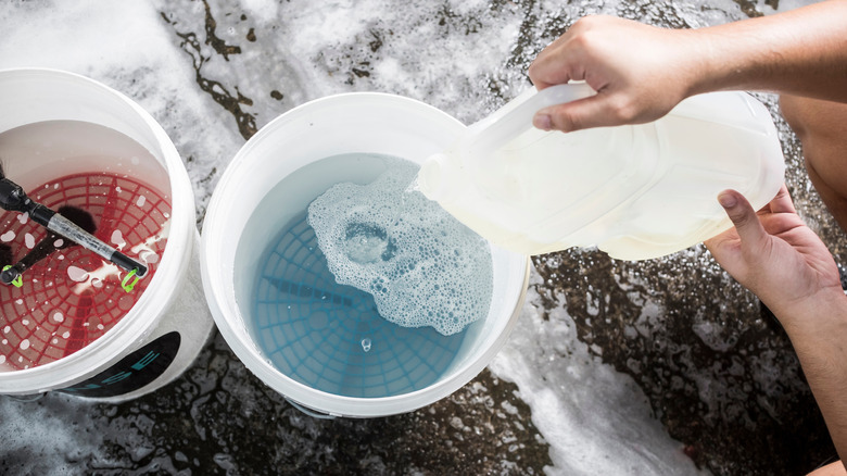 Mixing water and car shampoo in a bucket