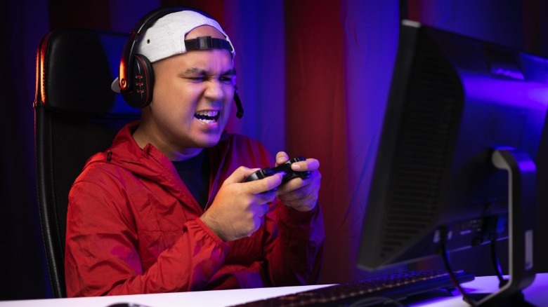 Visibly frustrated guy playing video games on a PC