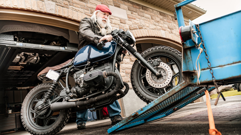 Senior man working on his motorcycle
