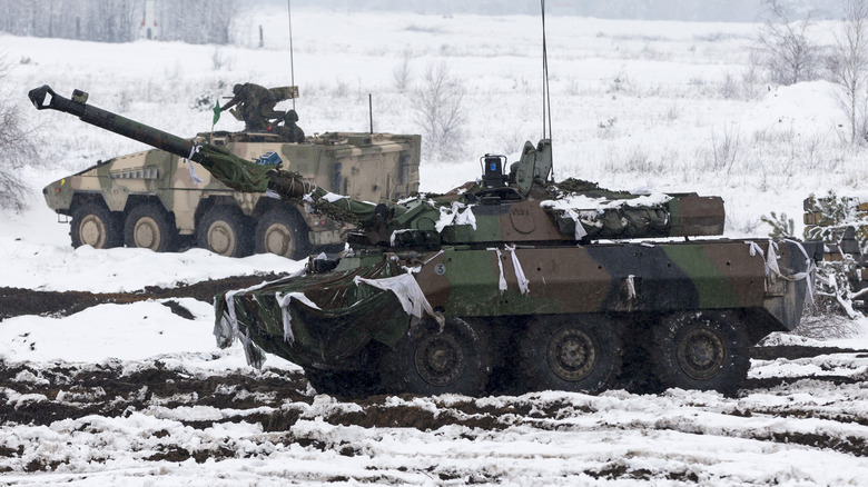 Armored cars driving in snowy landscape