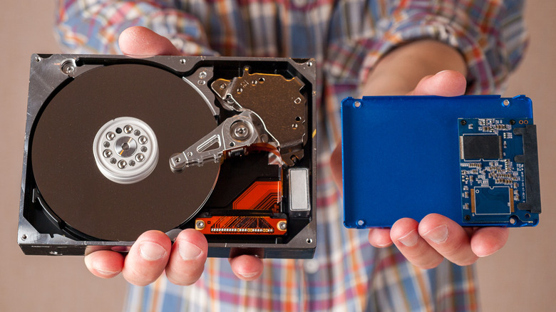 Man holding HDD and SSD