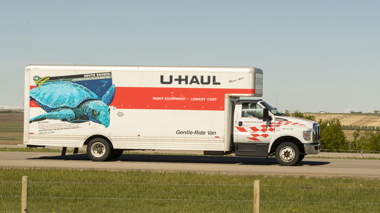 A U-Haul straight truck on the road, side view