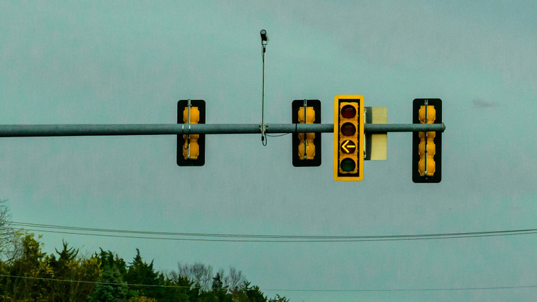 Yellow arrow pointed left at stop light