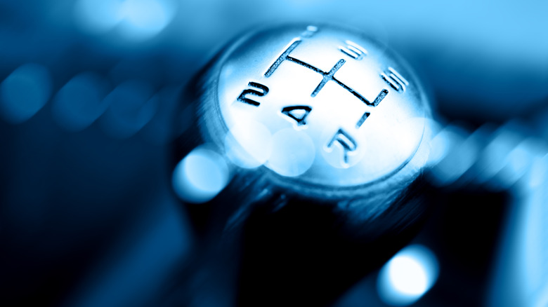 5-speed manual transmission shifter on blurred background