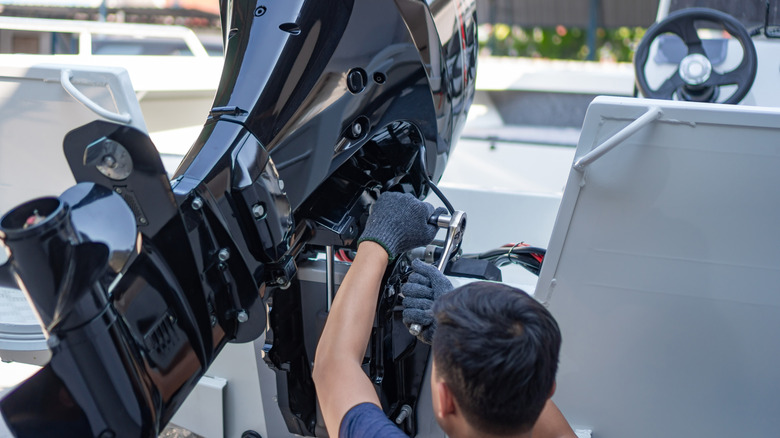 Mechanic repairing boat engine