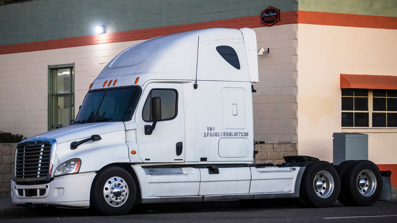 Side shot of a white Freightliner Cascadia with no trailer