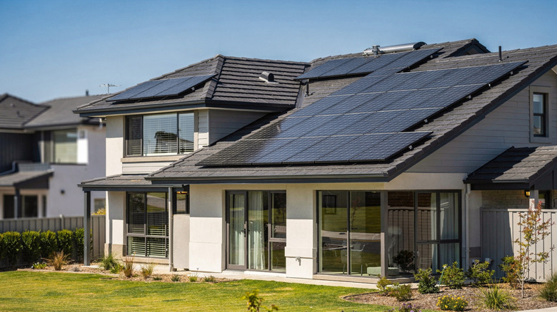 A modern home with solar panels installed on the roof