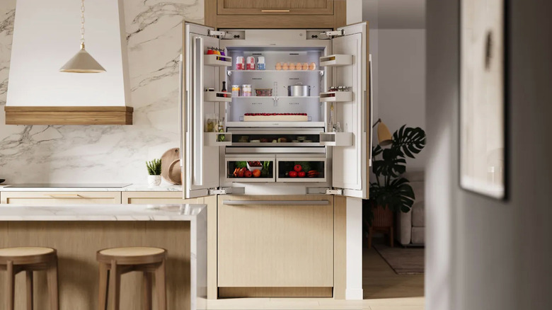A Bosch Benchmark fridge installed and left open in a luxury kitchen
