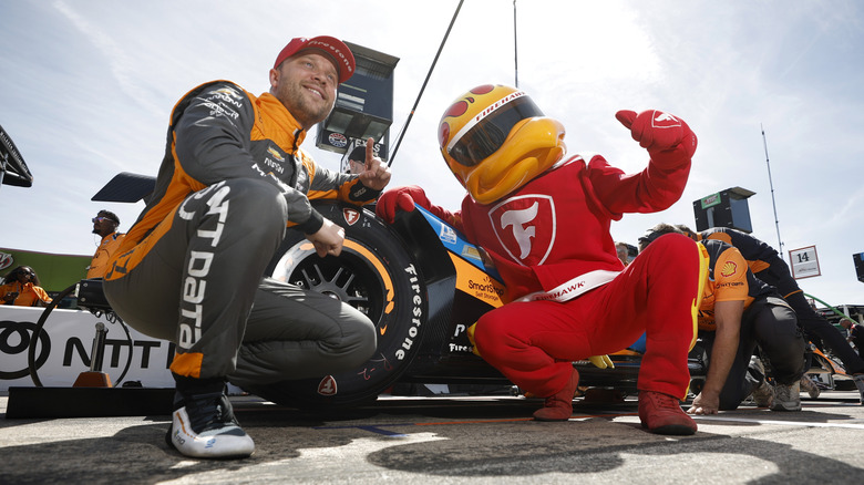 Low angle view of Firestone Firehawk mascot posing for photo during Indy race.