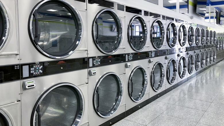 Commercial washing machines stacked in a row