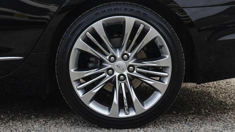 Close-up of a Goodyear tire installed on a black car.