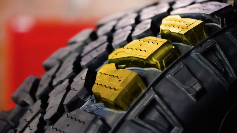 A close-up of a highlighted section of tread on a Goodyear Wrangler Duratrac tire