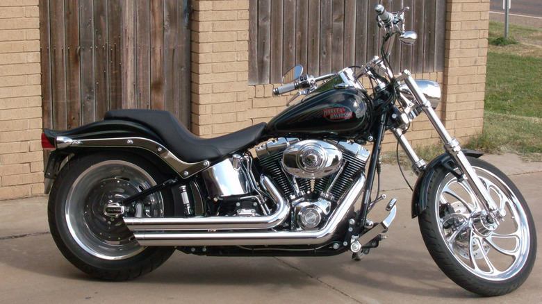 Harley-Davidson softail with Evolution engine parked in front of a yellow brick building.